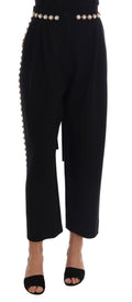 Pantalon noir en laine extensible avec cristaux de la marque Dolce & Gabbana, vue en gros plan sur le tissu et les détails.
