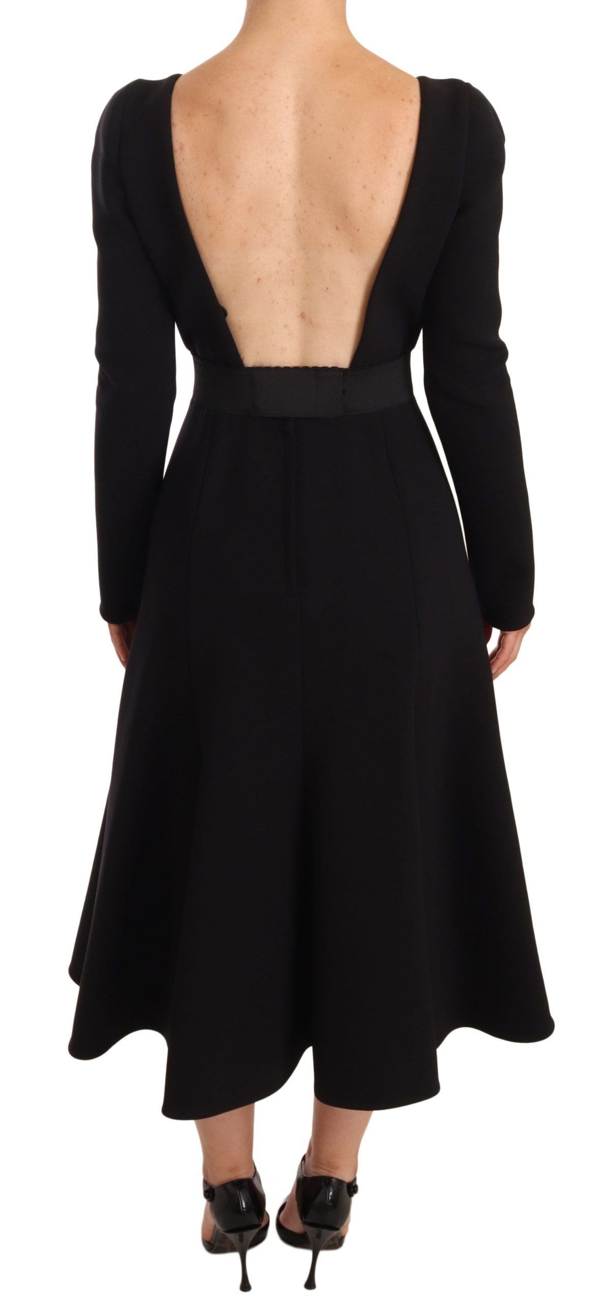 Robe noire en laine stretch de Dolce & Gabbana, coupe moulante et dos ouvert, élégante et sophistiquée.