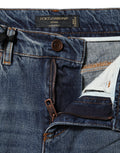 Jeans en denim bleu Dolce & Gabbana, coupe déchirée, taille mi-haute, tissu en coton, style décontracté et tendance.