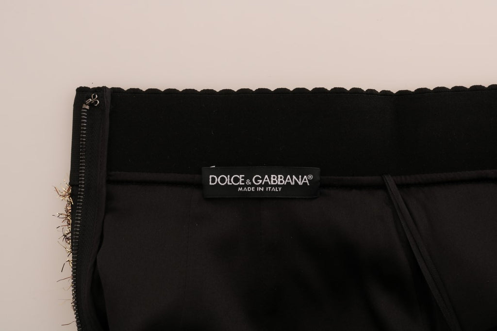 Mini jupe courte Dolce & Gabbana en or et noir, avec design élégant et tissu brillant.