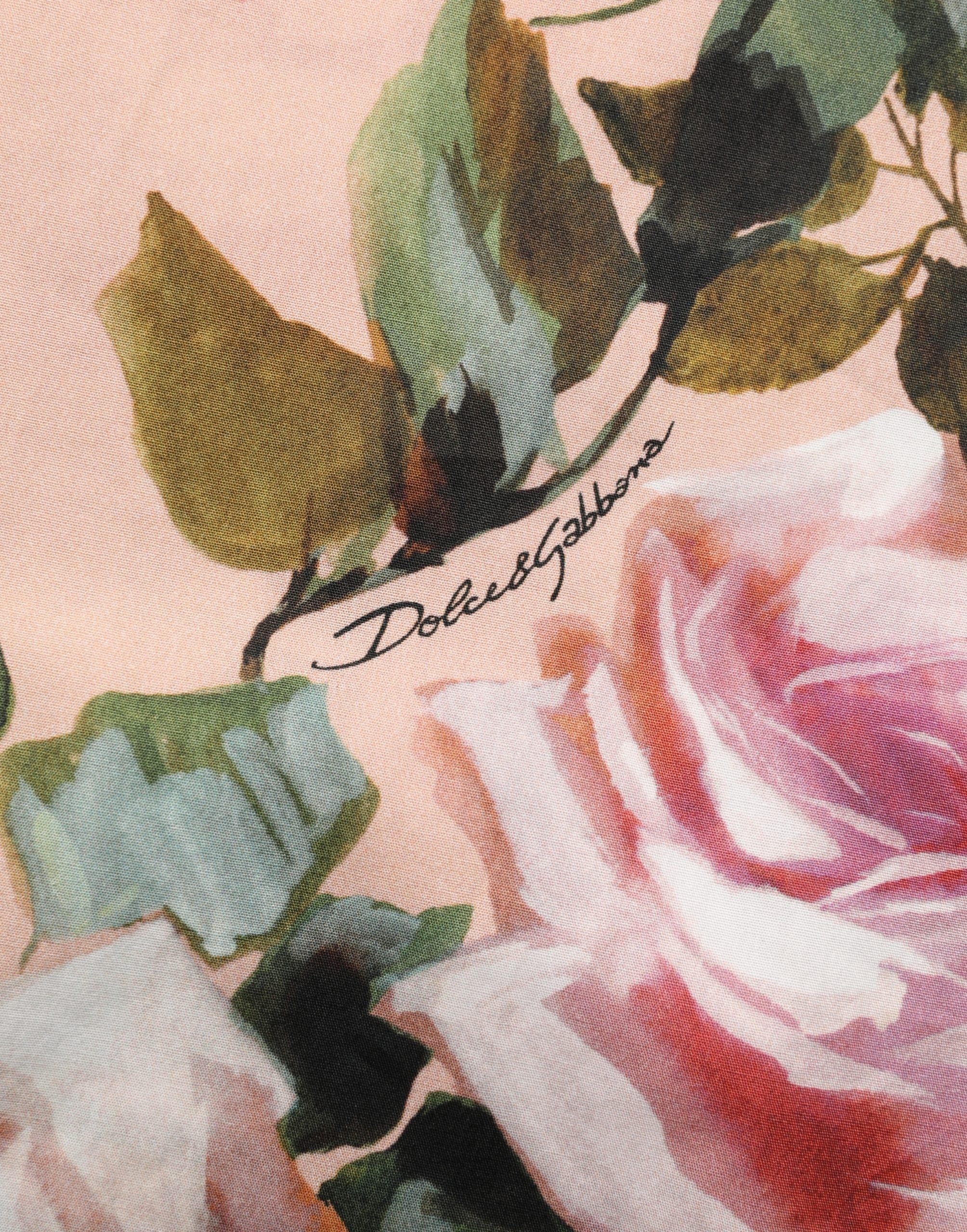 Chemise en coton rose à fleurs Dolce & Gabbana avec boutonnières, motif floral élégant et style féminin.