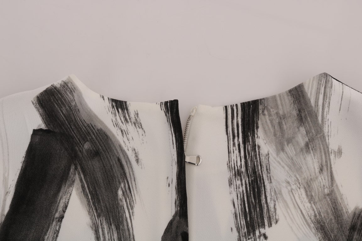 Blouse blanche et noire à rayures imprimées de Dolce & Gabbana, haut élégant pour femme, tissu léger et design sophistiqué.