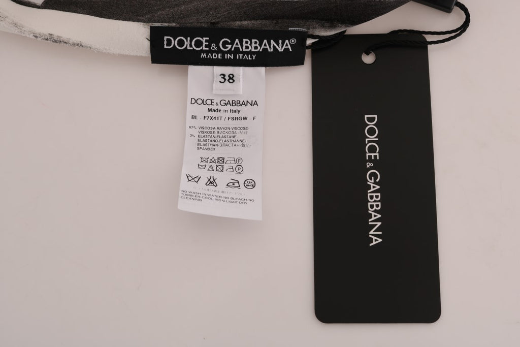 Chemisier Dolce & Gabbana à rayures blanches et noires, imprimé élégant, manches longues et coupe fluide.
