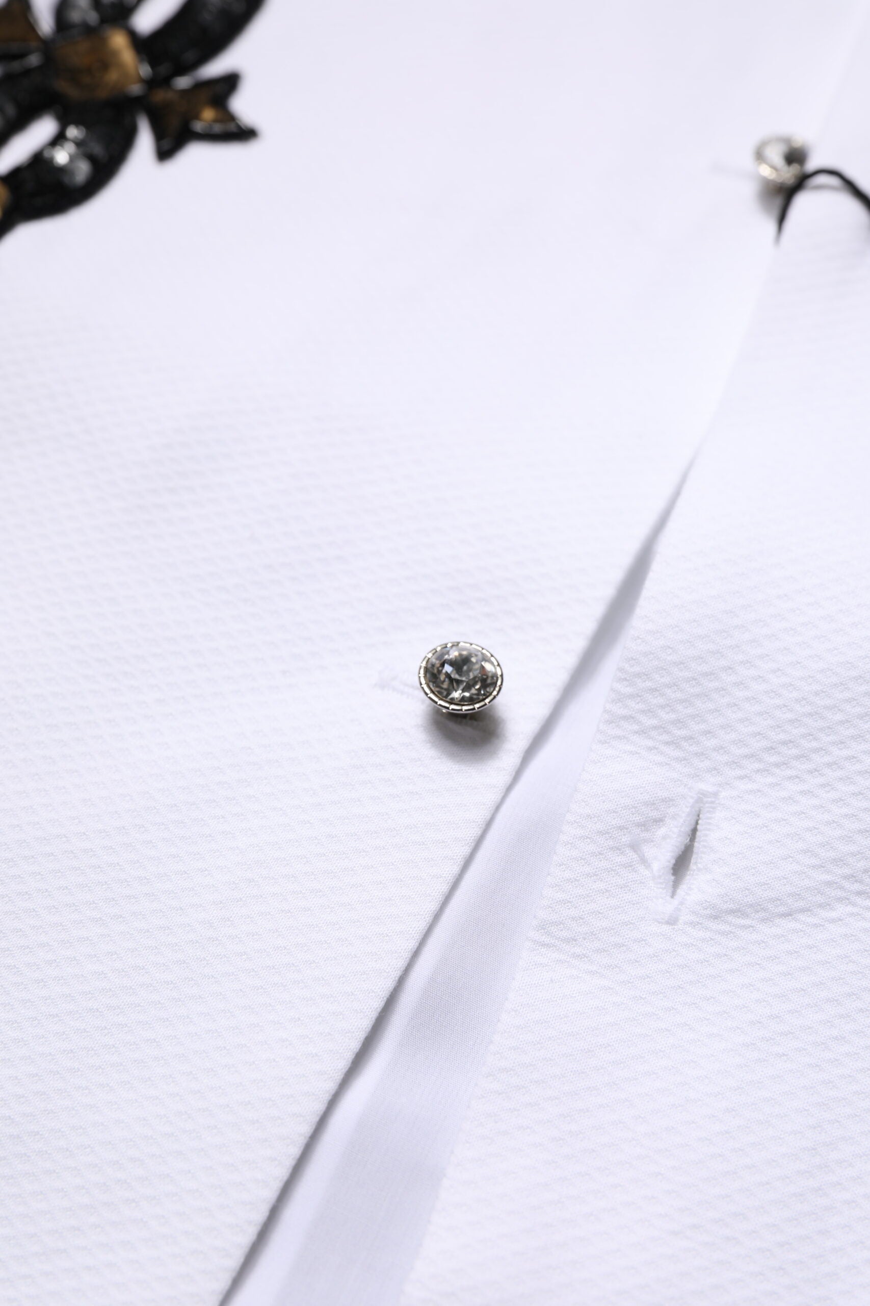 Chemise formelle blanche pour homme de Dolce & Gabbana avec embellissements dorés et détails élégants.