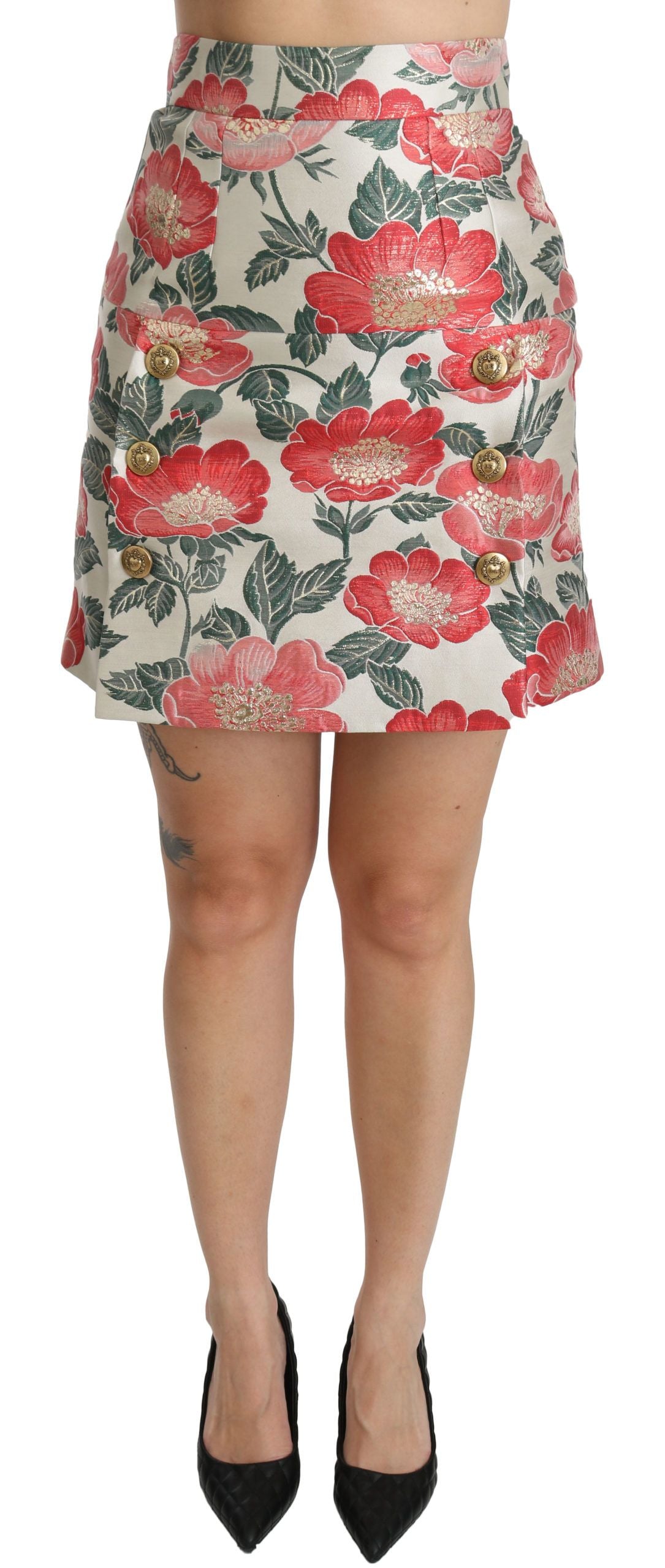Jupe courte haute taille Dolce & Gabbana à fleurs blanches, vertes et rouges, en tissu léger et élégant.