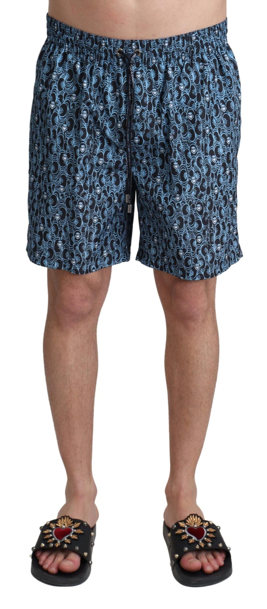 Shorts de bain Dolce & Gabbana à motif bleu, maillot de plage élégant avec imprimé coloré, pour un look estival sophistiqué.
