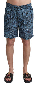 Shorts de bain Dolce & Gabbana à motif bleu, maillot de plage élégant avec imprimé coloré, pour un look estival sophistiqué.
