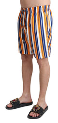 Maillot de bain homme Dolce & Gabbana à rayures multicolores, short de plage élégant avec motif coloré.