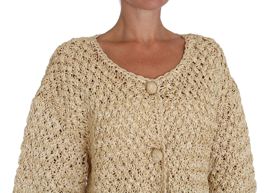 Cardigan beige en crochet en tricot de Dolce & Gabbana avec détails en rafia, vue de face sur un fond neutre.