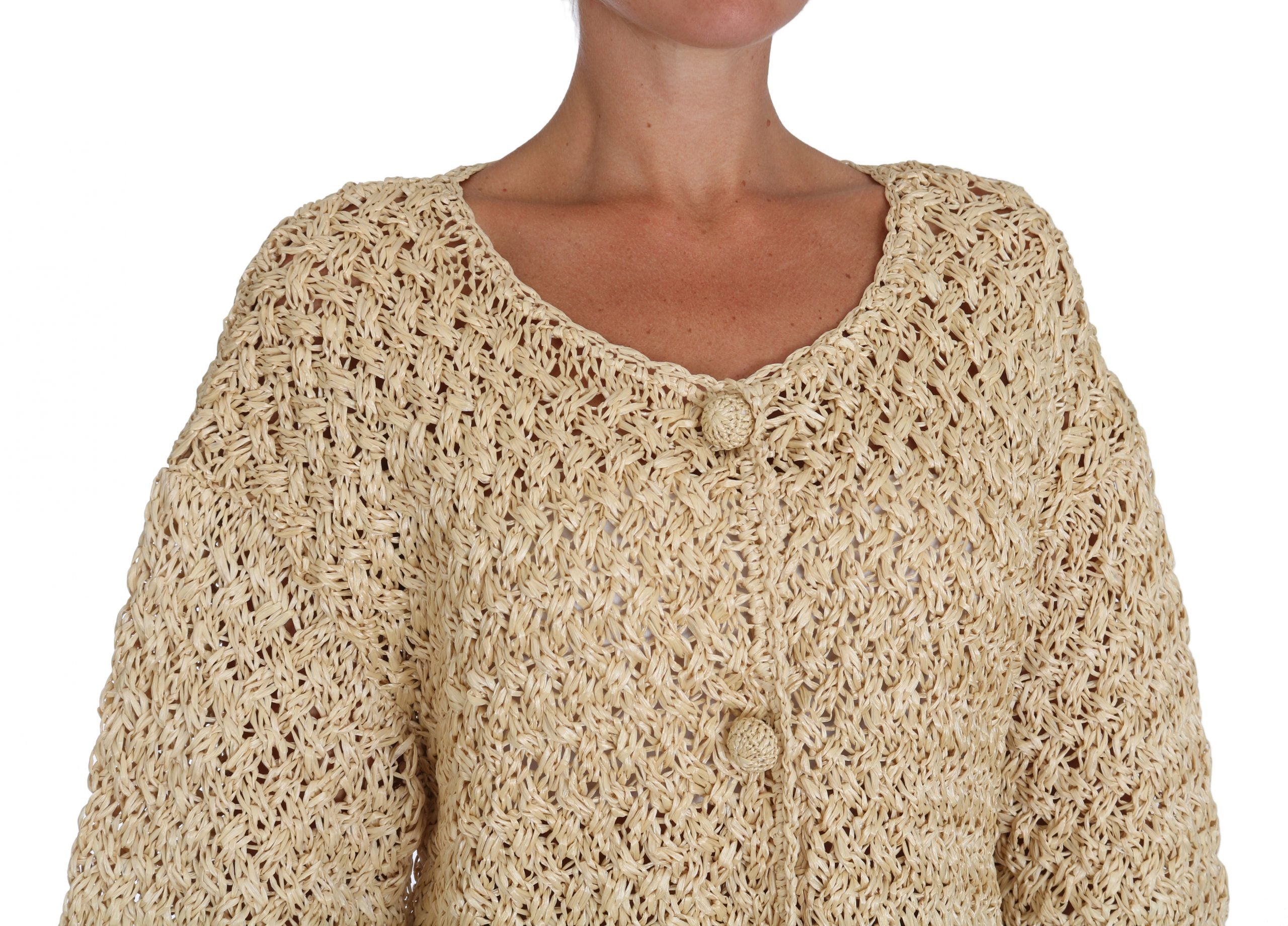 Cardigan beige en crochet en tricot de Dolce & Gabbana avec détails en rafia, vue de face sur un fond neutre.