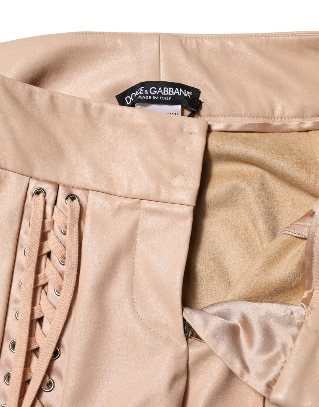 Pantalons skinny beige en dentelle à taille moyenne de Dolce & Gabbana, détails raffinés et coupe ajustée visible sur l'image.