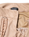 Pantalons skinny beige en dentelle à taille moyenne de Dolce & Gabbana, détails raffinés et coupe ajustée visible sur l'image.