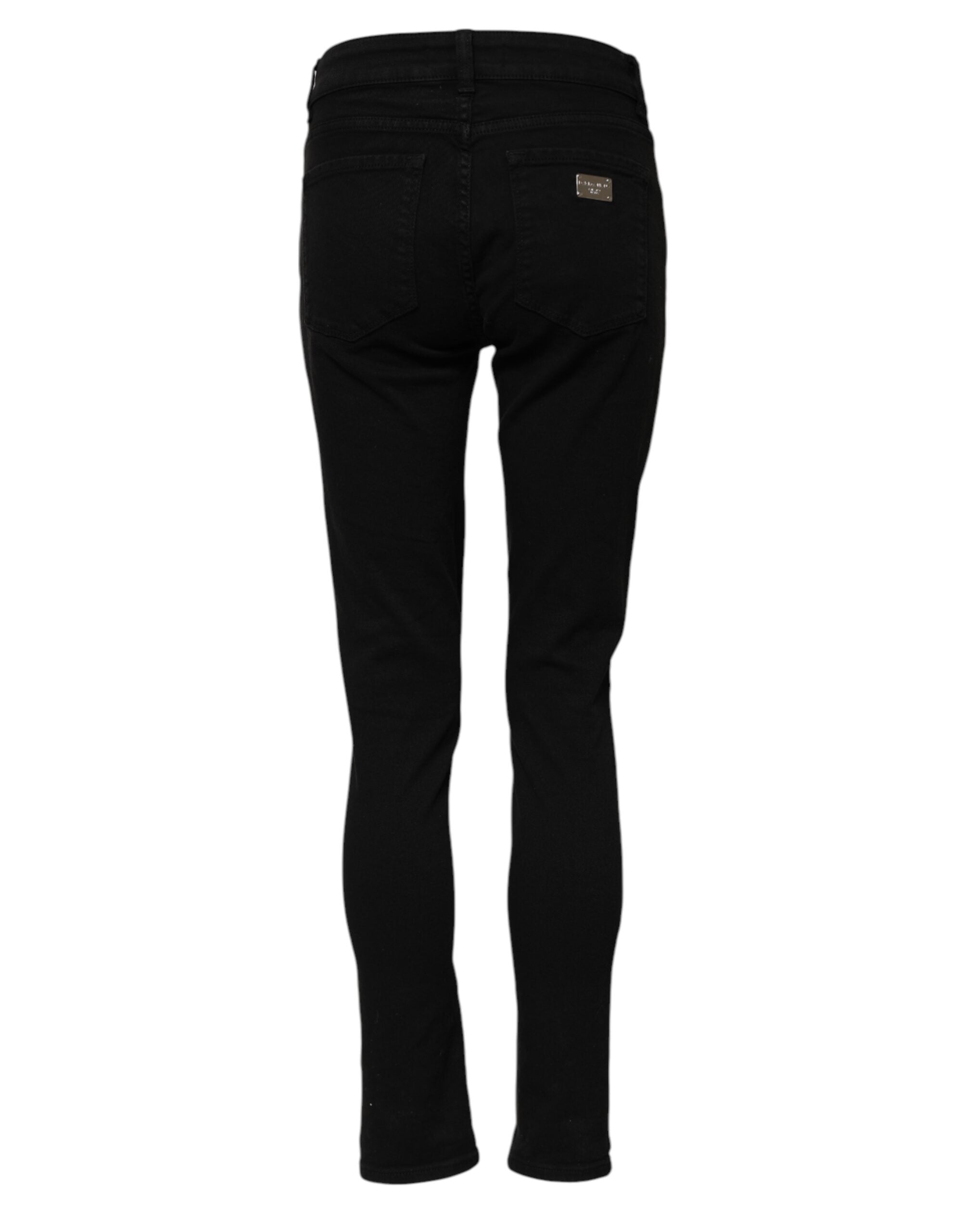 Jeans skinny en coton noir de Dolce & Gabbana avec logo, taille mi-haute et coupe ajustée, visibles sur l'image.