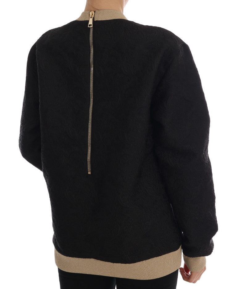 Pull Dolce & Gabbana en brocart noir avec fermeture éclair et motif conte de fées, portée sur un mannequin.