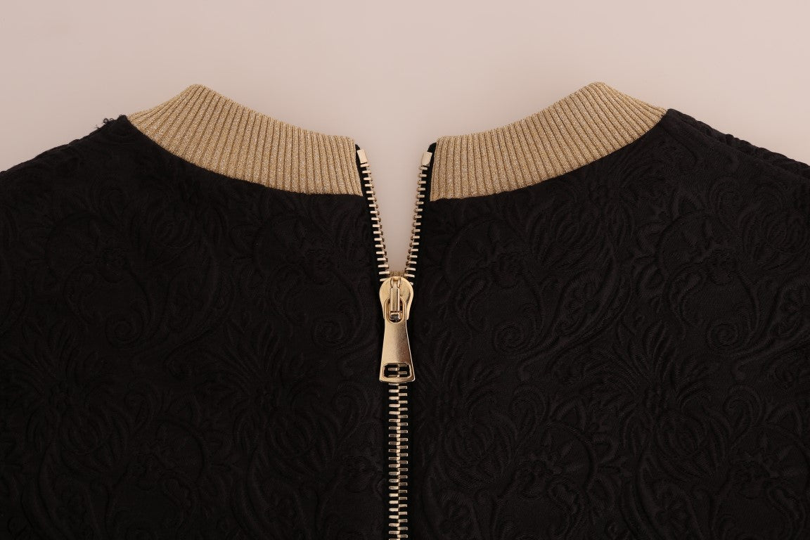 Pull Dolce & Gabbana en brocart noir avec fermeture éclair, style conte de fées, détails élégants et texture riche visible sur l'image.