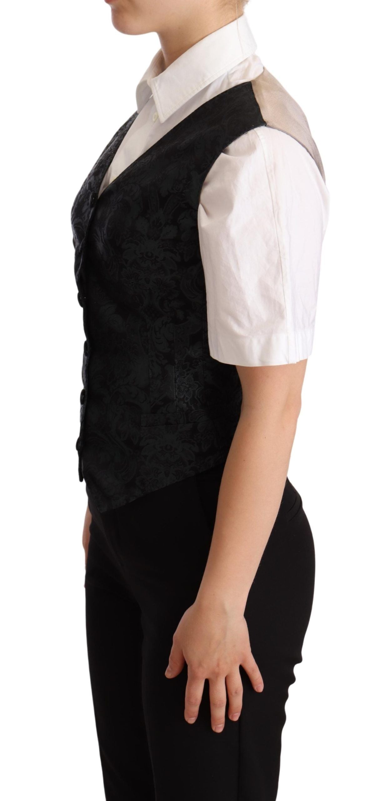Gilet en jacquard floral noir de Dolce & Gabbana avec taille cintrée et détails verts, vue de face.