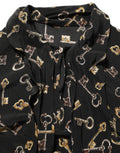 Blouse en soie noire Dolce & Gabbana avec motif de clés, col en ras du cou, détails élégants et style sophistiqué.