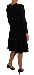 Robe longue en laine tricotée noire de Dolce & Gabbana avec manches longues et coupe ajustée, élégante et sophistiquée.