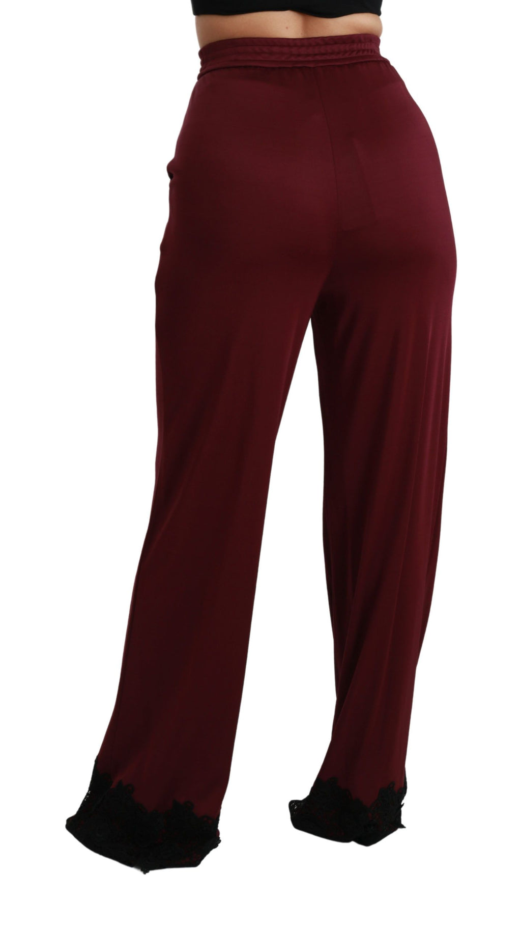 Pantalon noir en dentelle Dolce & Gabbana, taille haute, jambes larges et taille maroon, vue de face.