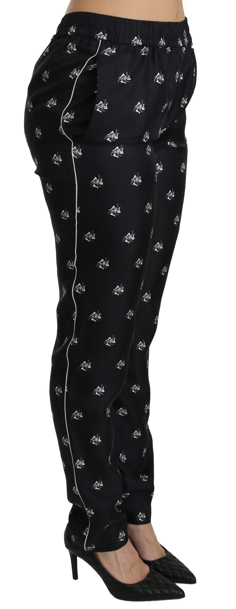 Pantalons en soie noire Dolce & Gabbana à motif imprimé, coupe skinny taille moyenne, vue de face.