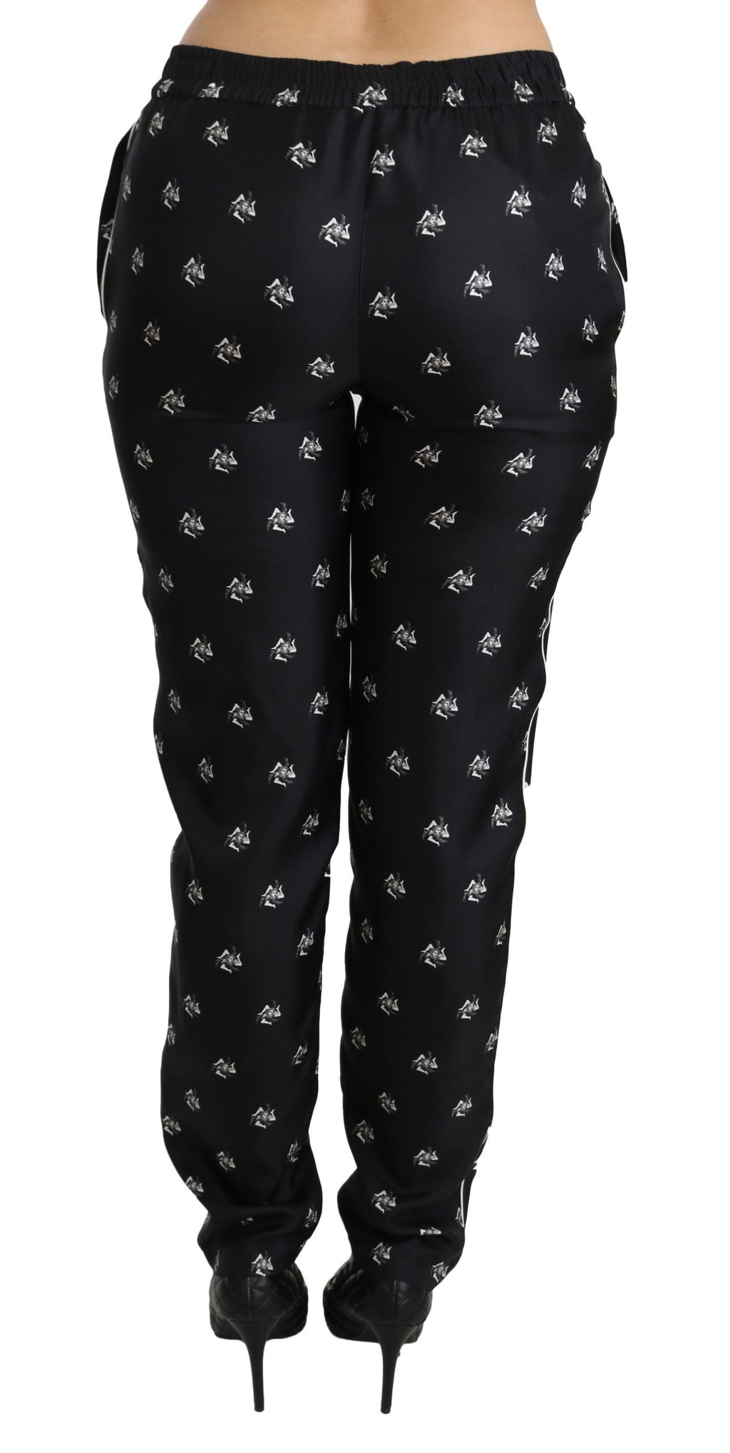 Pantalon skinny en soie noire à imprimé, taille mi-haute, de la marque Dolce & Gabbana, visible en détail sur l'image.