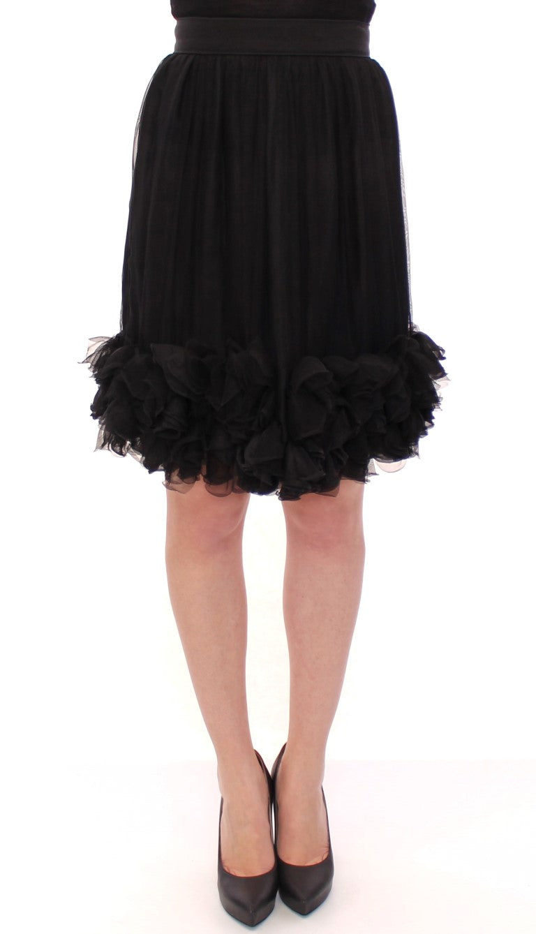 Jupe en soie noire transparente au-dessus du genou de Dolce & Gabbana, élégante et sophistiquée, visible en détail.