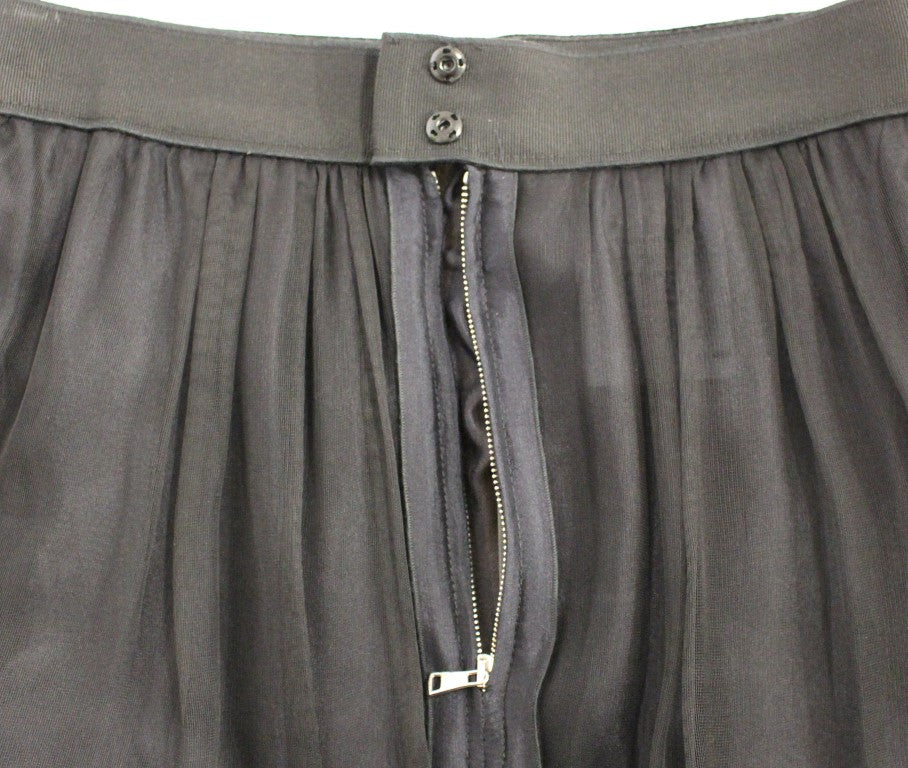 Jupe noire en soie transparente Dolce & Gabbana, courte au-dessus du genou, avec un style élégant et sophistiqué.