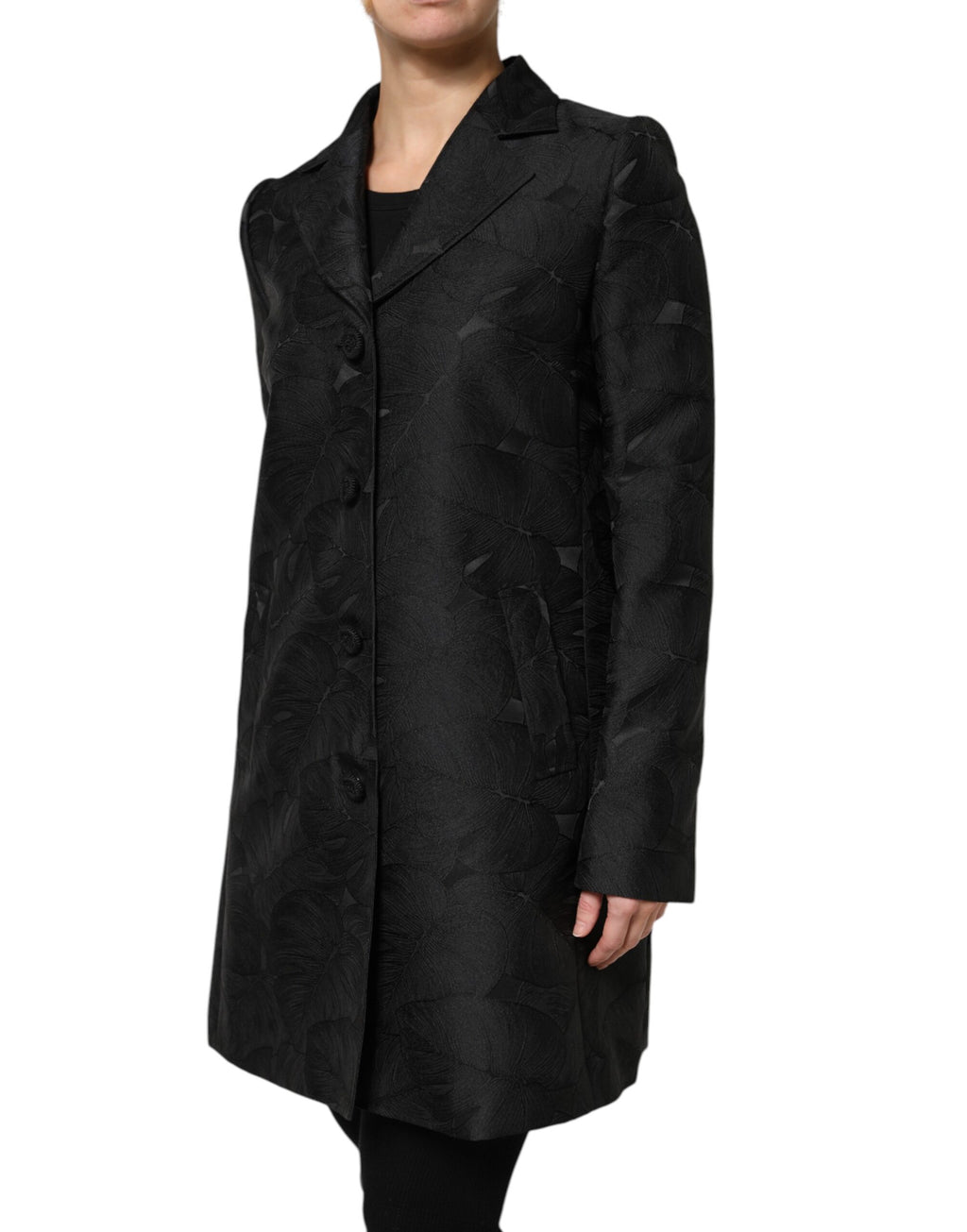 Manteau trench noir à un seul boutonnage de Dolce & Gabbana, veste élégante en tissu classique, visible avec col et détails sophistiqués.
