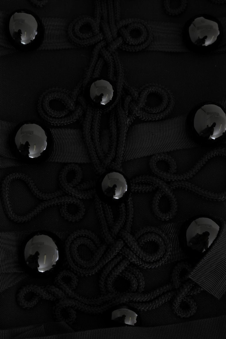 Veste trench en laine noire Dolce & Gabbana, élégante et sophistiquée, avec ceinture et détails classiques.