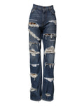 Jeans en denim droit bleu de Dolce & Gabbana avec déchirures et effet usé, en coton, sur un fond neutre.