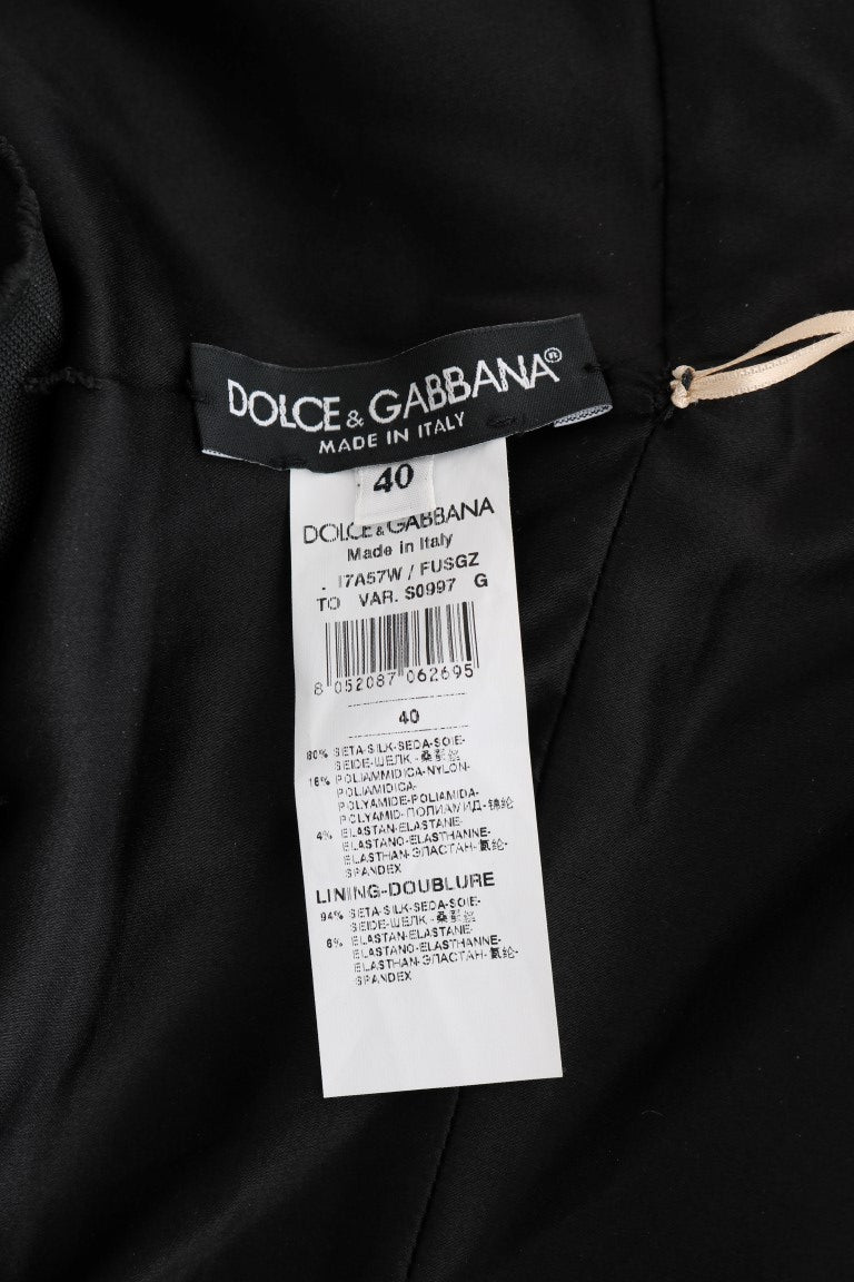 Combinaison en soie stretch dorée Dolce & Gabbana, ajustée, avec détails élégants, portée sur un mannequin.