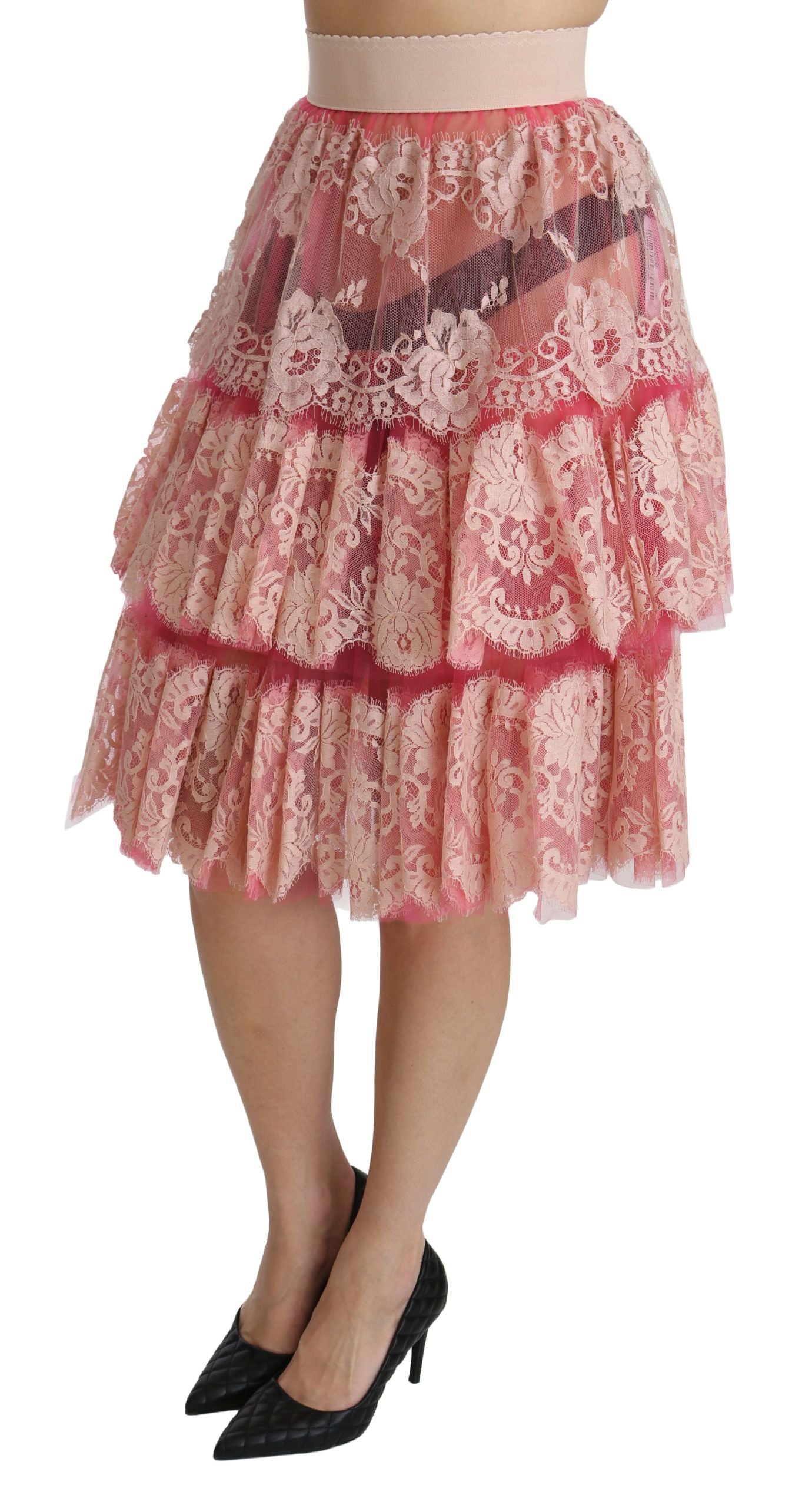 Jupe longue à la taille haute en dentelle rose de Dolce & Gabbana, style superposé et élégant, longueur jusqu'aux genoux.