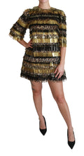 Robe courte en polyester noir avec motifs léopard dorés, de la marque Dolce & Gabbana, vue de face sur mannequin.