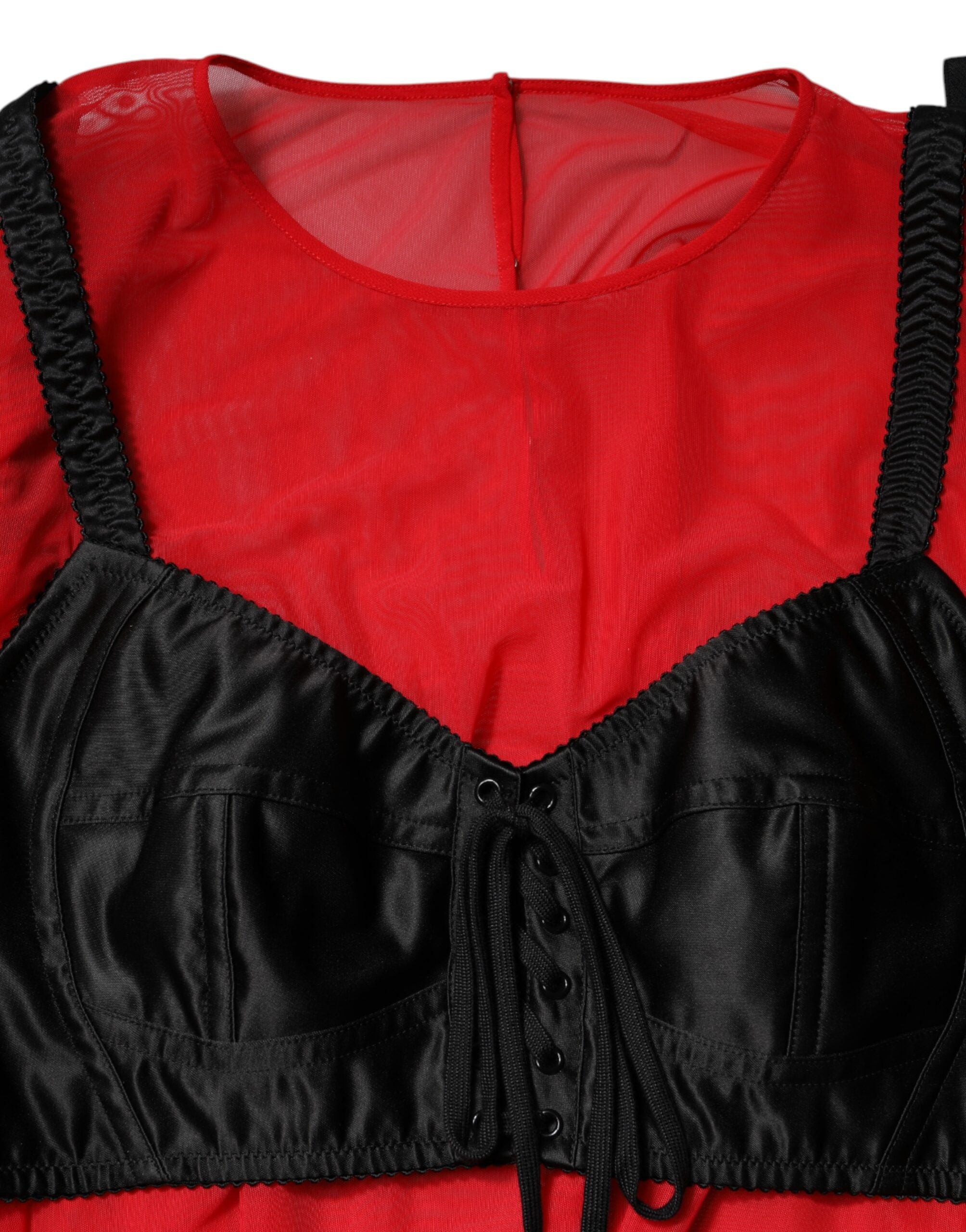Haut Dolce & Gabbana en rouge et noir avec bustier, manches longues, détails élégants et tissu sophistiqué.