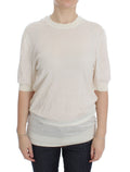 Pull Dolce & Gabbana blanc en cachemire 100%, doux et élégant, avec finition fine visible sur l'image.