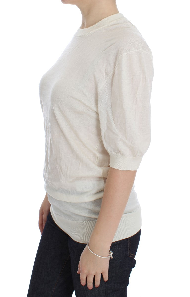 Pull en cachemire blanc Dolce & Gabbana, 100% cachemire, avec col rond et finition douce, porté de face.
