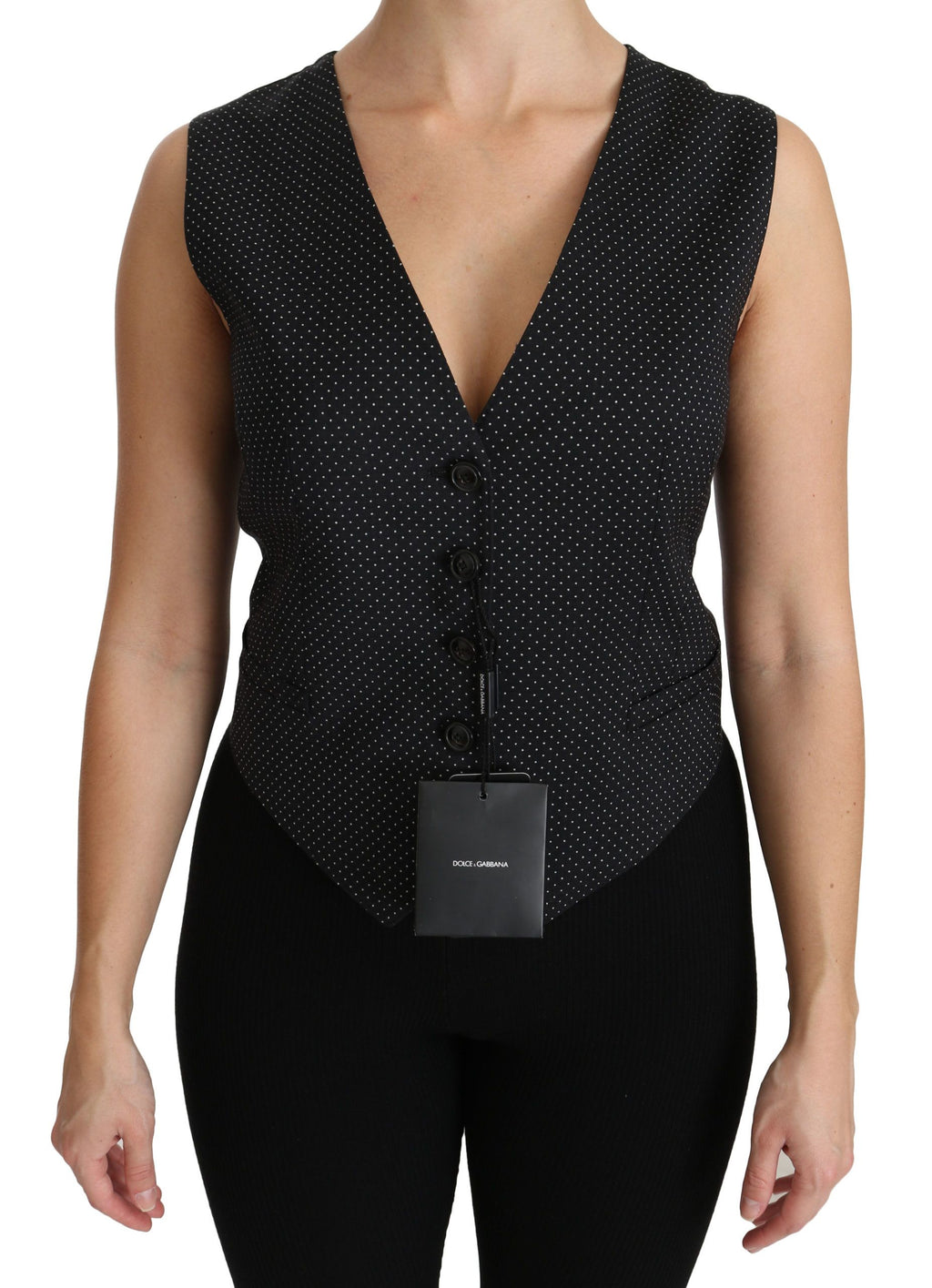 Veste sans manches noire Dolce & Gabbana à pois, avec blouse élégante, visible en détail dans l'image.