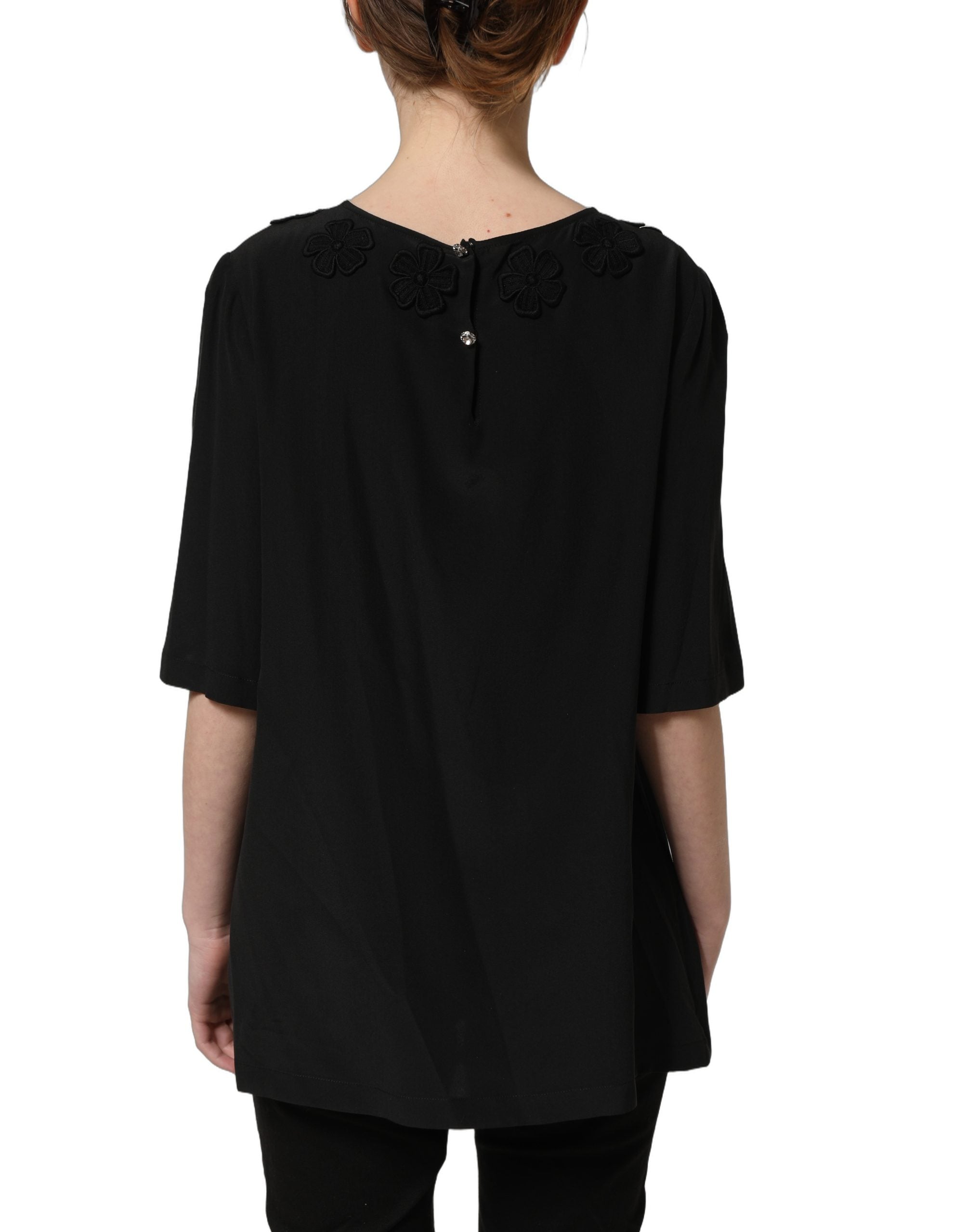 Blouse en soie noire Dolce & Gabbana avec appliqué de cœur floral, design élégant et féminin.