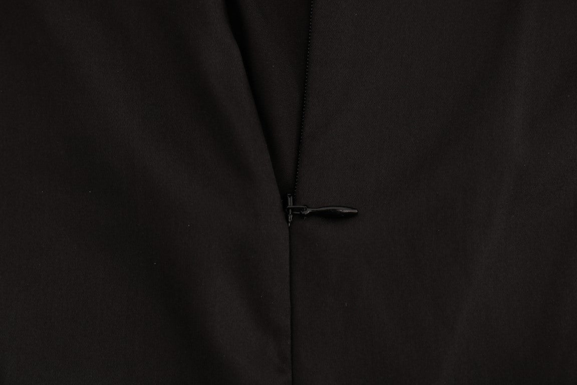 Haut en dentelle en mesh noir en soie de Dolce & Gabbana, détails floraux élégants, aspect transparent et sophistiqué.