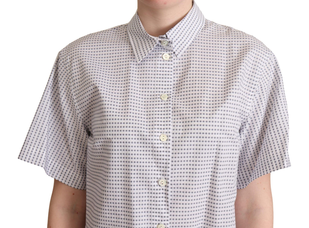 Chemise blanche à pois Dolce & Gabbana avec col, en tissu léger, affichant un style élégant et féminin.