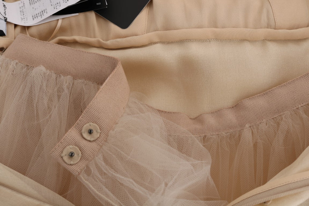 Robe en soie dorée Dolce & Gabbana ornée de cristaux, élégante et sophistiquée, vue de face sur un fond neutre.