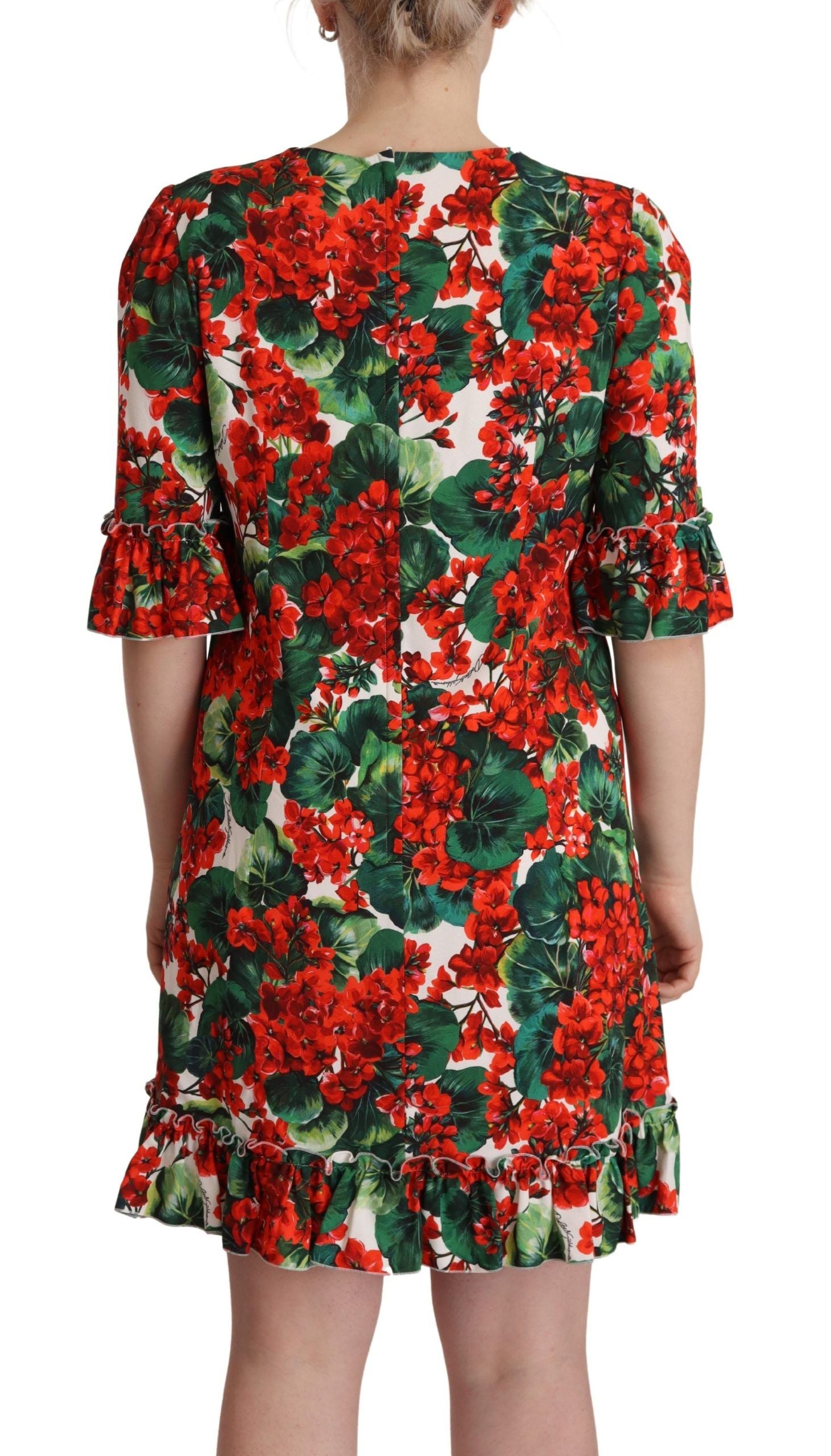 Robe de soirée Dolce & Gabbana à fleurs multicolores et rouges, coupe shift élégante, tissu fluide et détails floraux sophistiqués.