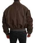 Veste Dolce & Gabbana en brun avec logo crâne, ornée de perles et de détails de couronne, style audacieux et élégant.
