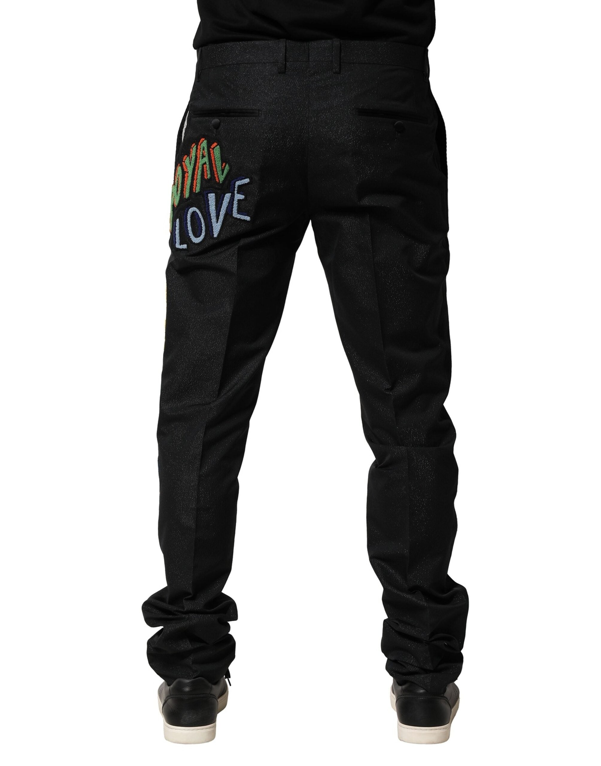 Pantalon homme noir Dolce & Gabbana avec broderie graphique élégante et détails modernes.