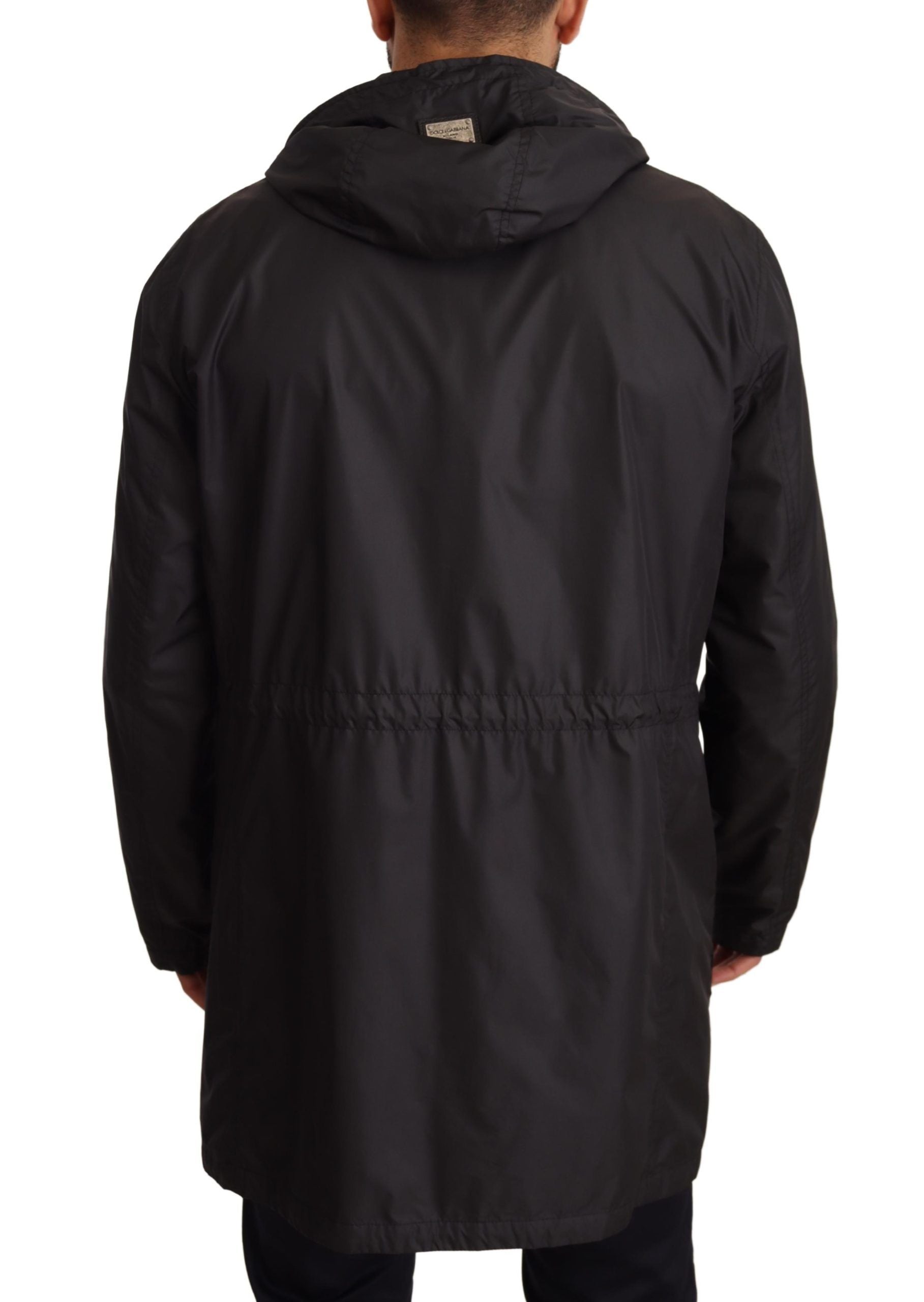 Veste trench noire pour homme avec capuche de la marque Dolce & Gabbana, détails du tissu et design élégant visible.