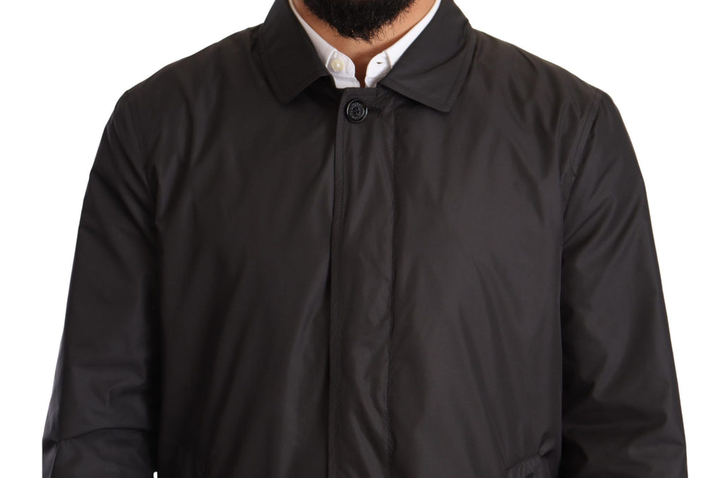 Manteau trench noir pour homme en polyester de Dolce & Gabbana, veste élégante avec col et boutons visibles.