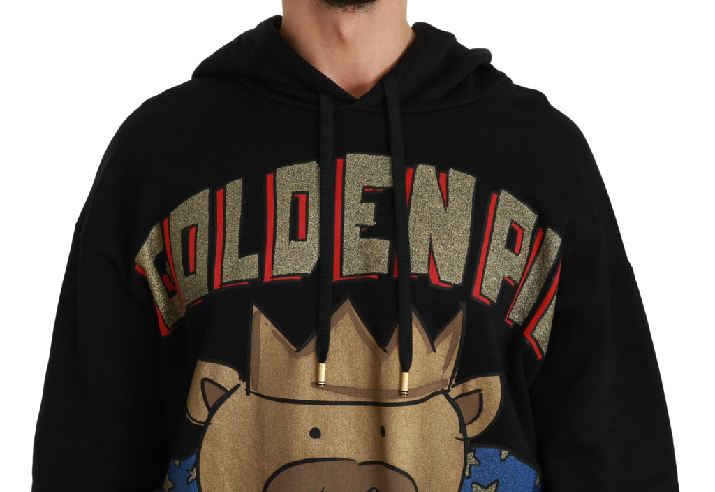 Pull noir Dolce & Gabbana avec capuche et motif cochon de l'année, détails visibles sur le devant et la texture du tissu.