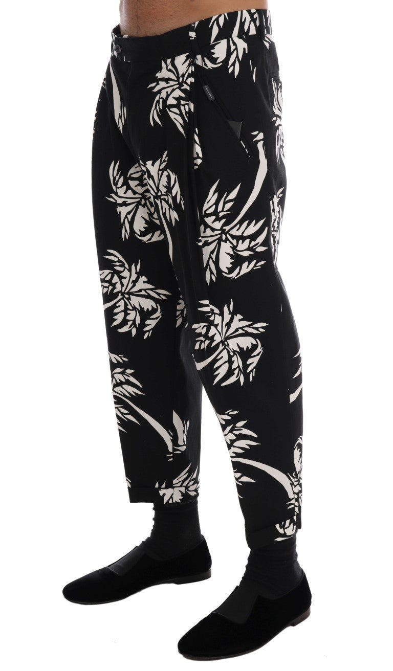 Pantalons en coton stretch noirs Dolce & Gabbana avec motif arbre, ajustés et élégants, visibles dans l'image.