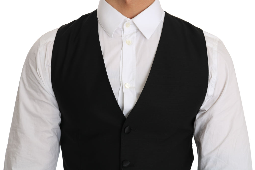 Gilet noir en laine Dolce & Gabbana, veste cintrée élégante avec col en V et boutons, pour femme ou homme sophistiqué.