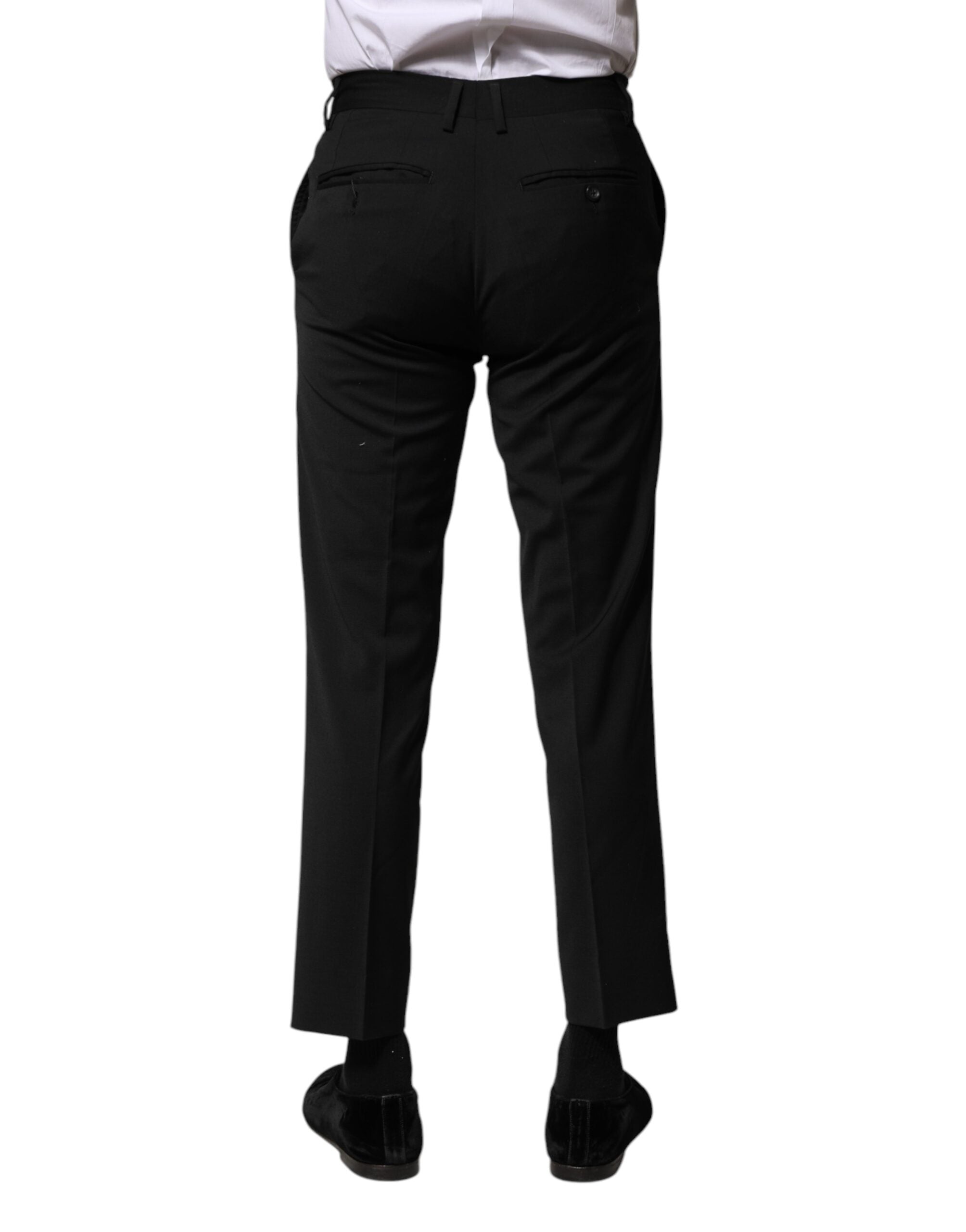 Pantalon homme formel Dolce & Gabbana en laine noire, coupe courte, élégante et sophistiquée, visible en gros plan.